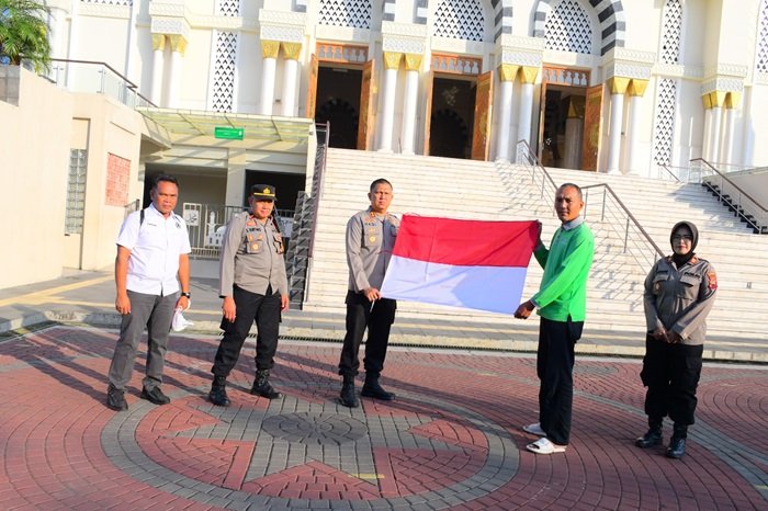 WhatsApp Image 2025-08-06 at 17.06.53 Kapolres Karanganyar AKBP Hadi Kristanto membagikan bendera merah putih kepada masyarakat di halaman Masjid Agung Madaniyah