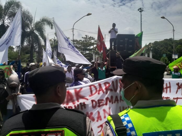 Ratusan buruh yang tergabung dalam Aliansi Gerakan Buruh Demak (GEBRAK) menggelar aksi damai di depan Kantor Bupati Demak, Senin (22/12), mengawal proses penetapan UMK dan UMSK tahun 2026 serta menuntut peningkatan kesejahteraan pekerja. (Foto: Sam)